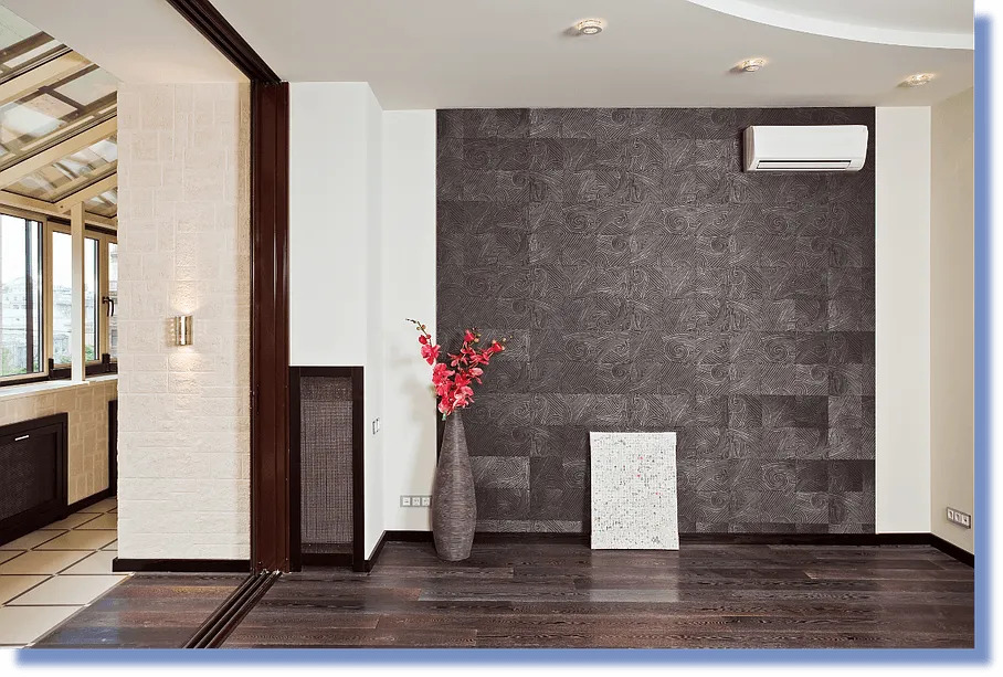 Salon moderne avec climatisation alamo-sarl à Limoux, mur sombre, parquet et accents rouges,